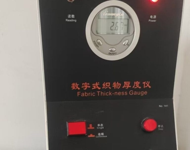 Measuring filter fabric thickness with a precision gauge